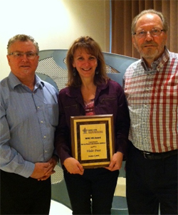 Stephen Kennedy, project manager and Robert Porter, project manager at the Wood Manufacturing Council present Violet Frost with her award.