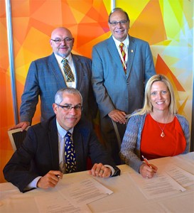 Wayne Tebb, dean, School of Business, Surrey campus, KPU (back left); Anthony Ariganello, president and CEO, HRMA (back right); Shannon Railton, chair, HRMA (front right); and Dr. Sal Ferreras, provost and vice-president academic, KPU (front left) sign a partnership agreement at HRMA’s Annual Conference + Tradeshow on April 29, 2015. 